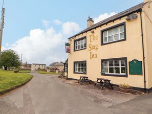 The Stag Inn with a signboard, outdoor seating, and a traditional pub setting. - The Loft Apartment @ The Stag Inn (Maryport)