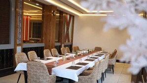 A conference room with a long table, chairs, and a modern interior design. - Patram Haveli (Roorkee)