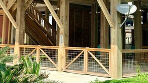 A wooden structure with a balcony, a satellite dish, and a number sign. - Ocean View•New Build • sleeps 9• Fenced Yard (Bolivar Peninsula)