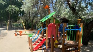 A playground with various play structures, including a slide, climbing area, and swings. - Bungalow 'Mobil-home Narbonne Plage' with Shared Pool, Private Terrace and Air Conditioning (Narbonne)