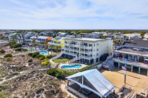 A coastal resort with multiple buildings, a swimming pool, and a beach area. - Oceanfront 3BR Condo with Panoramic Beach Views | Isle of Palms (Isle of Palms)
