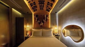 A hotel room with a large bed, a round mirror, and a ceiling decorated with animal and geometric patterns. - PYNT HOTEL 8 (Ho Chi Minh City)