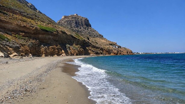A coastal beach with a rocky cliff and a small building on top. - Hotel Elena - Cozy Seaside Double Suite in Skyros (Skiros)