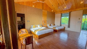 A spacious room with a large bed, a smaller bed, a desk, and a chair. - Corbett Hidden Grove (Ramnagar)