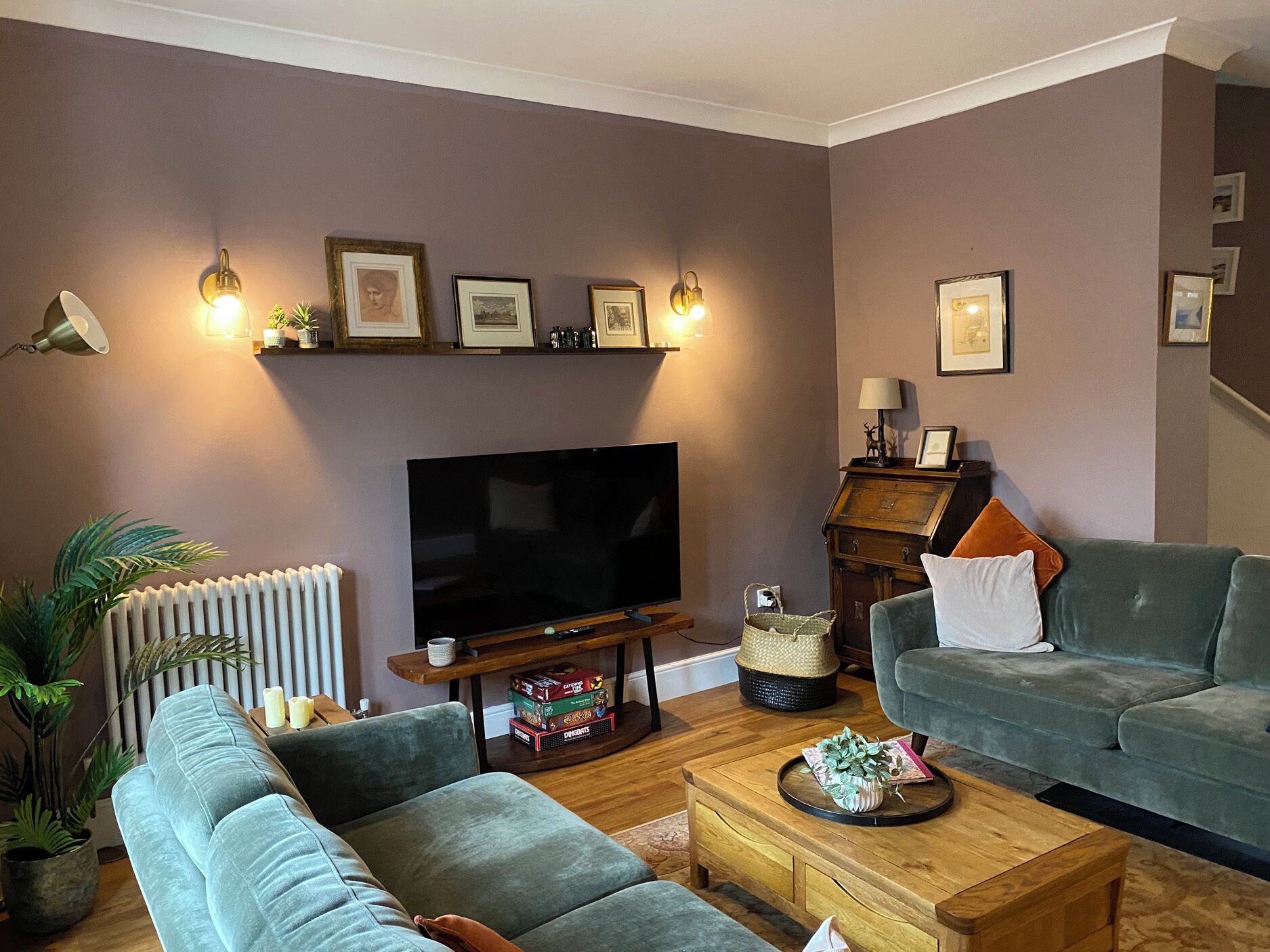 A living room with a flat-screen TV, two sofas, a coffee table, and a fireplace.