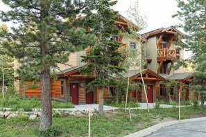A log cabin with a balcony, surrounded by trees. - Golf Course Property, Allows Pets, BBQ, Underground Parking, Laundry (Mammoth Lakes)