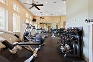 A gym with treadmills, elliptical machines, and a rack of dumbbells. - Direct Intracoastal Waterway condo in Canopy Walk #745! (Palm Coast)