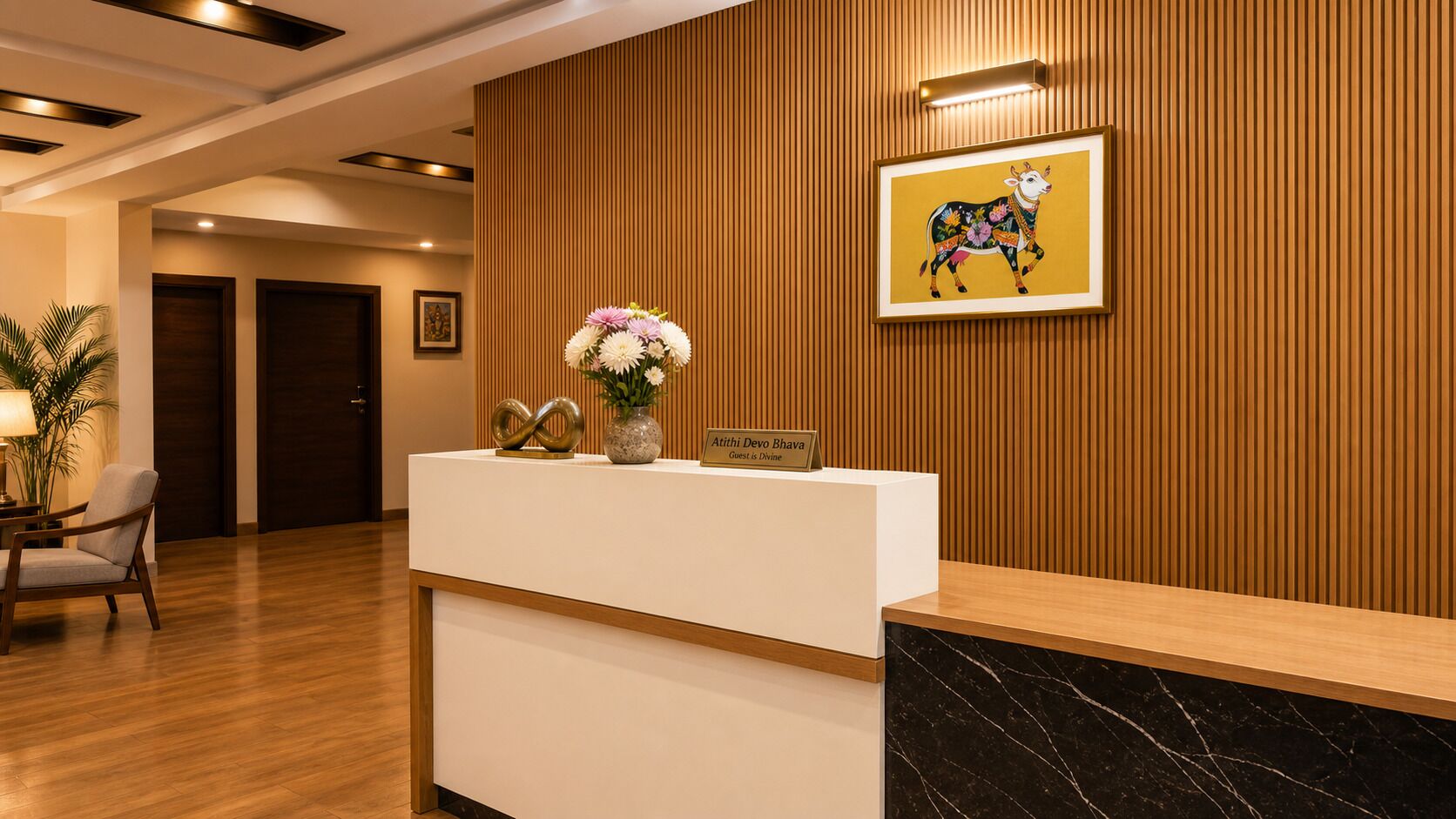 A reception desk with a wooden panel wall, a framed artwork of a cow, and a vase with flowers.