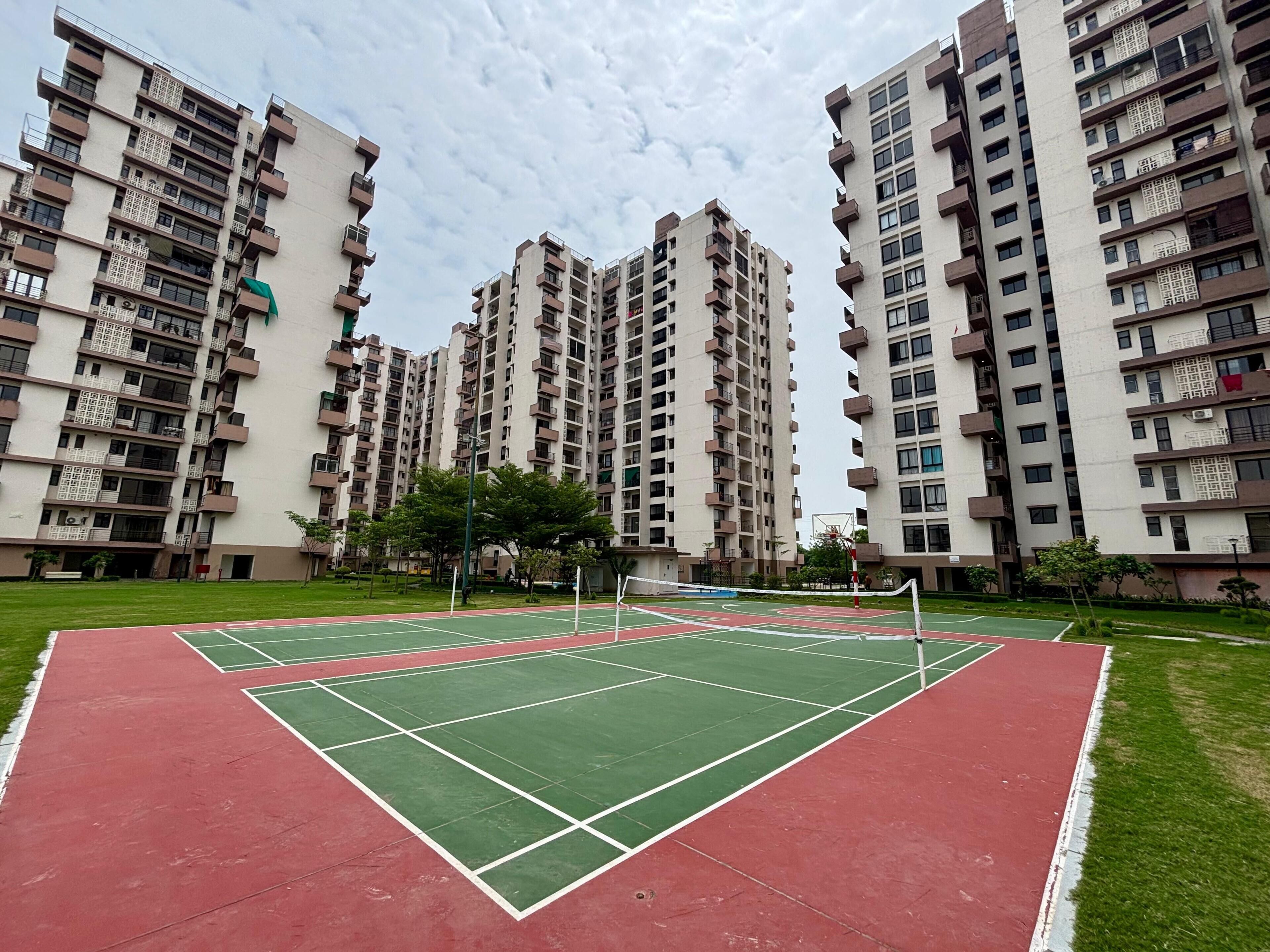 A sports court surrounded by high-rise residential buildings.