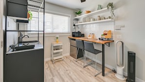 A compact kitchen with a dining area, a ceiling fan, and a built-in heater. - 1 Mi to Military Base: Cozy Imperial Beach Studio (Imperial Beach)
