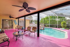 A pool area with chairs and a ceiling fan. - Themed Interior, Poolside Fun! Villa Near Disney (Davenport)