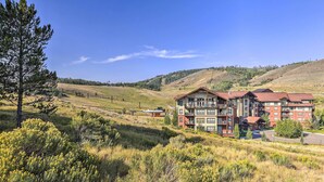 A multi-story hotel with a modern architectural style, situated in a hilly area with natural surroundings. - Ski-in/ski-out! Modern Mountainside Stay in Granby (Granby)