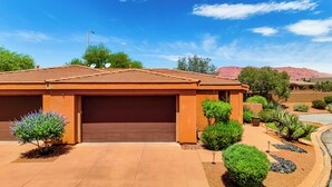 A residential house with a garage, surrounded by landscaped gardens and a clear sky. - Pool & Hot Tub Access! Gated Santa Clara Getaway (Santa Clara)