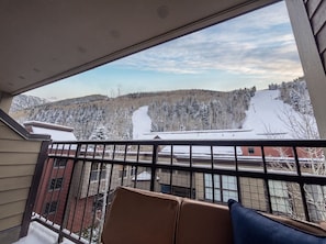 A balcony with a view of a snowy mountain landscape.