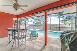 A covered outdoor area with a pool, chairs, and a table. - Heart of Lake County! Family Escape w/ Lanai, Pool (Tavares)