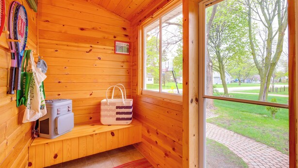 A wooden cabin with a bench, a suitcase, and a bag. - 1/2 Mi to Lake & Dtwn! Elk Rapids 'cozy Cottage' (Elk Rapids)