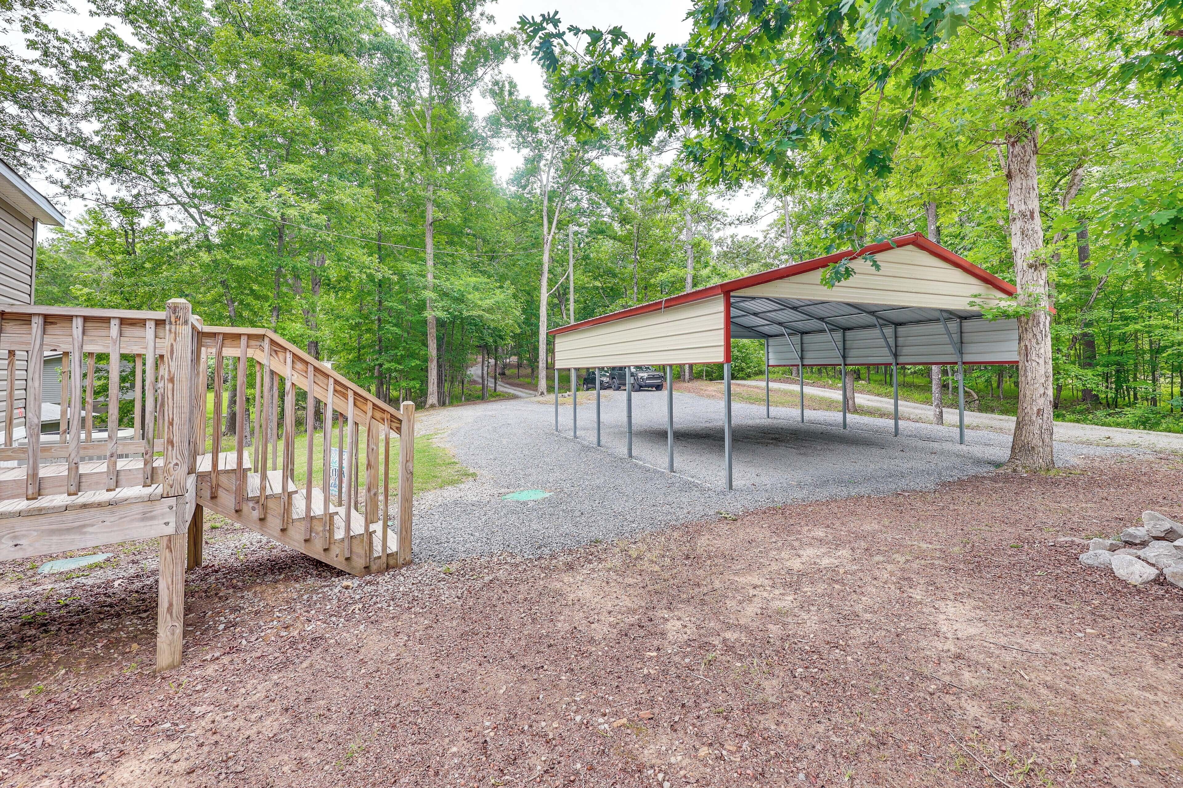 A covered outdoor area with a wooden deck and a gravel path.