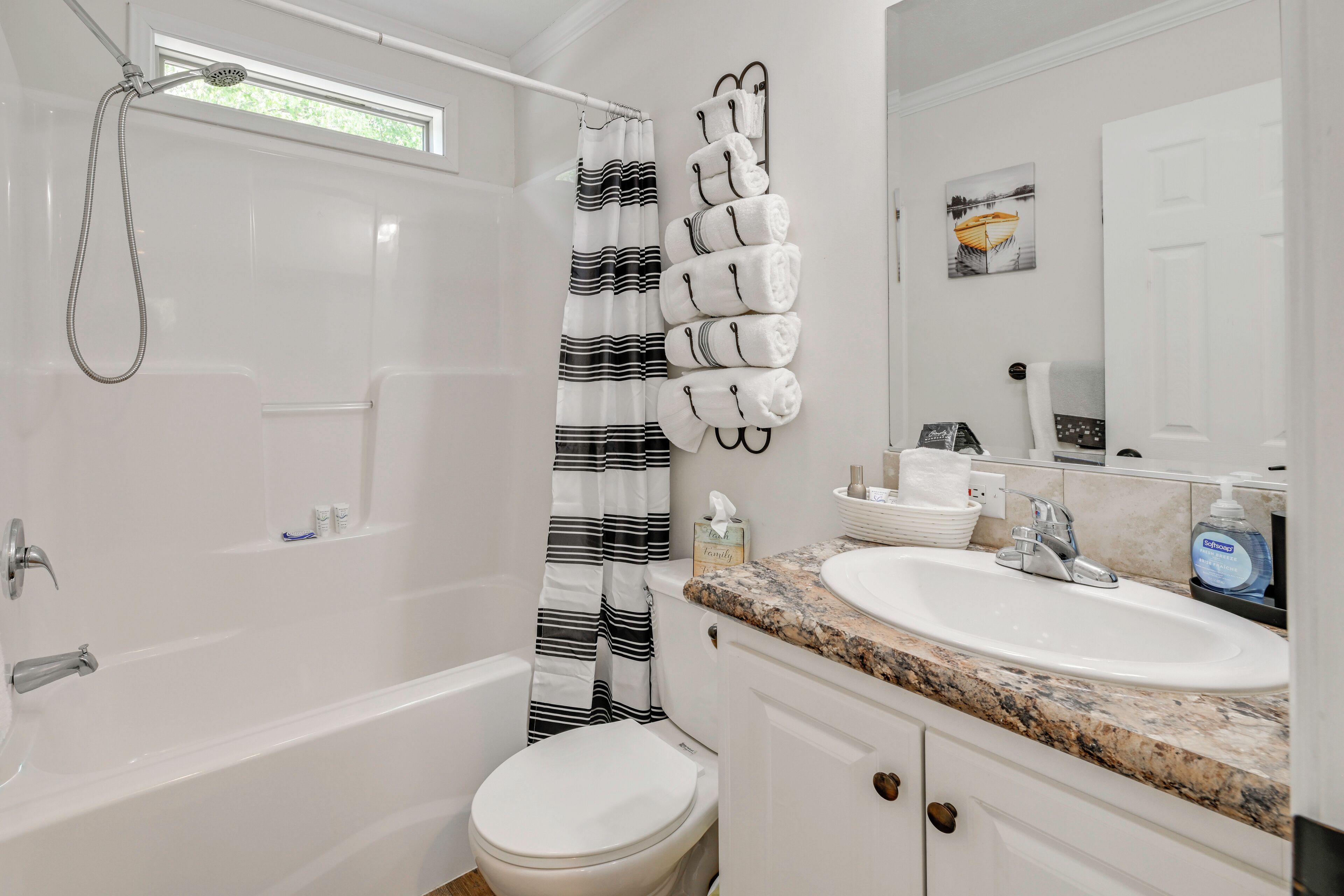 A bathroom with a bathtub, toilet, and sink.