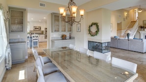 A spacious kitchen with a dining area, a chandelier, and a fireplace. - Combined Retreat w/ Epic Views in Simi Valley! (Simi Valley)