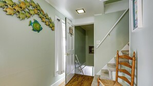 A staircase with a wooden chair, a fish wall art, and a door leading to another room. - Near Trails! Riverside 2-unit Combo in Franklin (Franklin)
