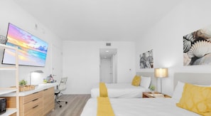 A modern hotel room with a bed, bedside tables, a desk, and a chair. - Stylish Studio | Bay, Marina & Sunset View (Hallandale Beach)