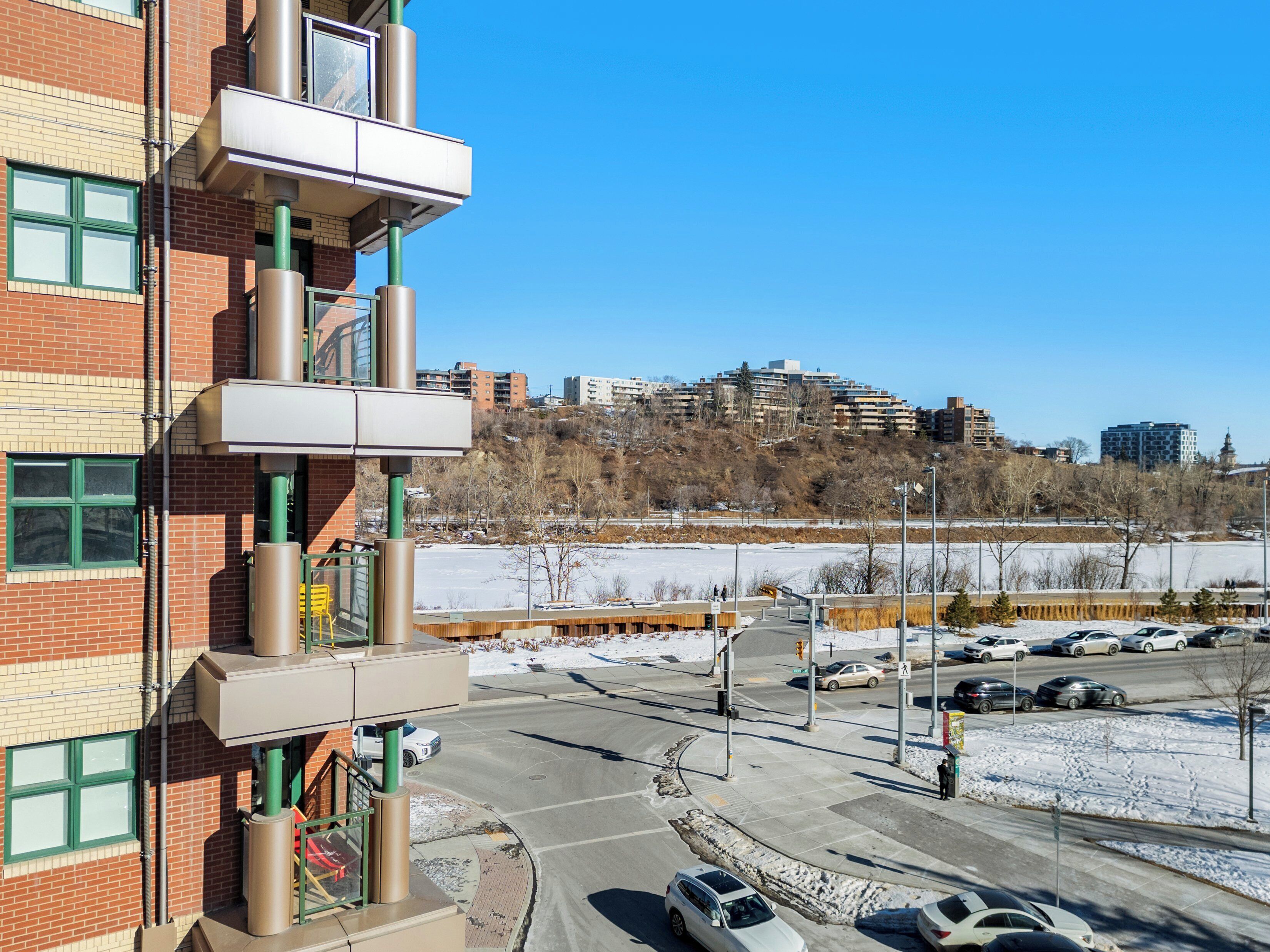 A multi-story building with a parking lot in front.