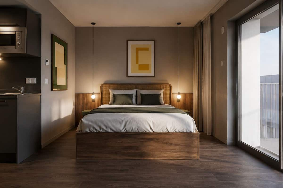 A modern bedroom with a bed, bedside lamps, a wall-mounted artwork, and a view through a large window.