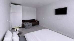Ein modernes Schlafzimmer mit Bett, Sofa, Fernseher und Kleiderschrank.