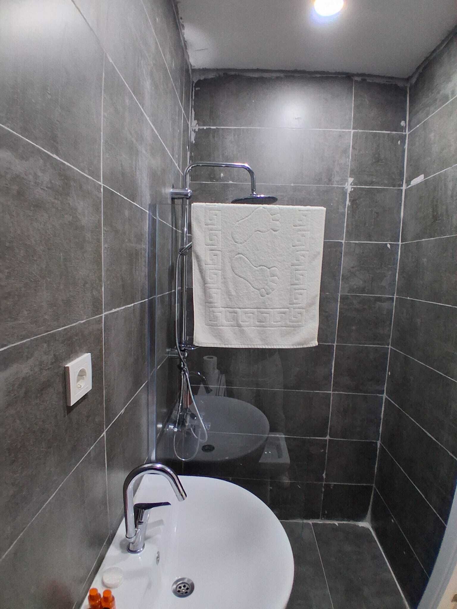 Shower, hair dryer, slippers, towels