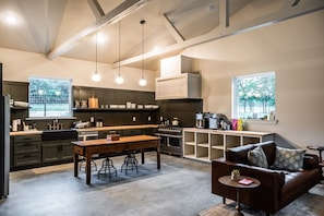 A modern kitchen with a dining area, bar, and seating.