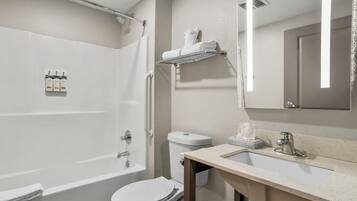 A bathroom with a bathtub, toilet, sink, and a towel rack.