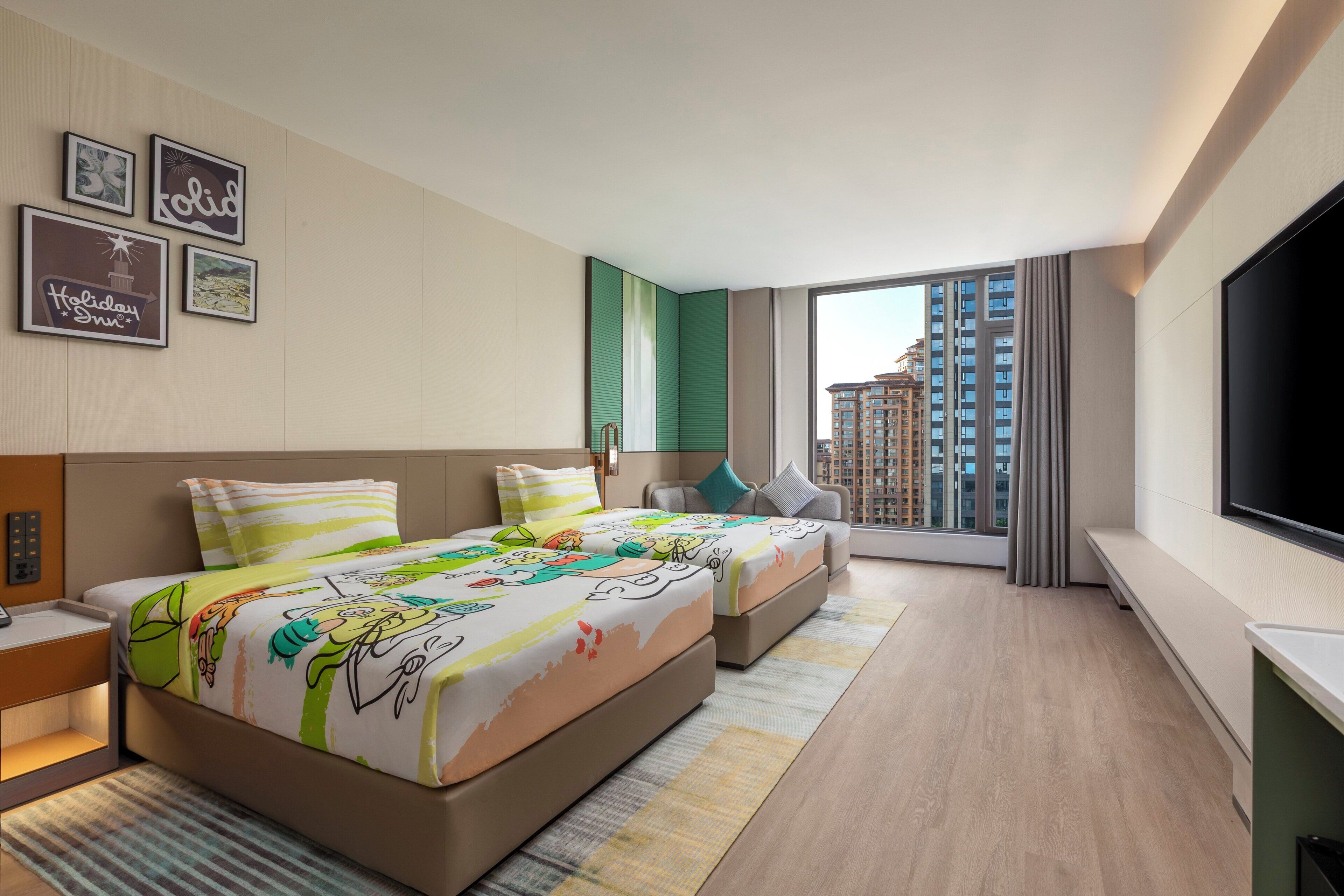 A hotel room with two beds, a TV, a large window, and artwork on the wall.