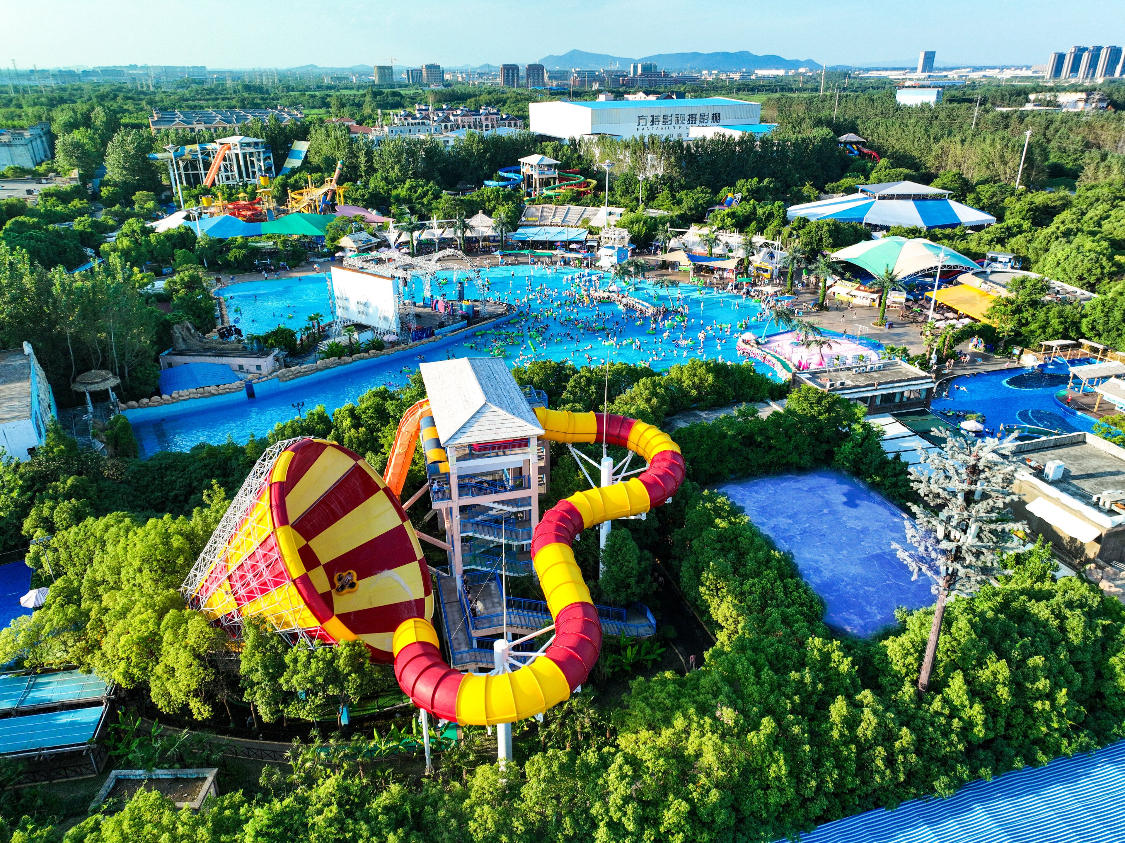 A water park with multiple pools, slides, and a large water slide.