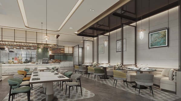 A modern dining area with a long table, multiple chairs, and a kitchen in the background.