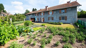 A two-story house with a garden in front.