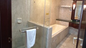 A modern bathroom with a glass-enclosed shower, a bathtub, and a vanity with a mirror. - Berjaya Times Square Apartment (Kuala Lumpur)