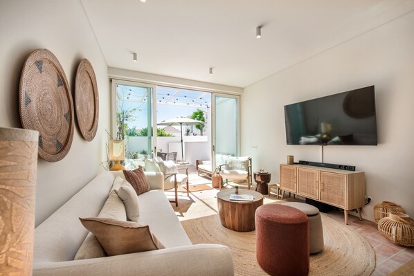 A modern living room with a sofa, coffee table, and TV.