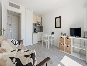 A compact living space with a kitchenette, a dining area, a TV, and a bed. - Convenient Riviera Retreat With Pool (Grasse)