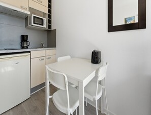 A compact kitchenette with a microwave, coffee maker, and a small refrigerator. - Convenient Riviera Retreat With Pool (Grasse)