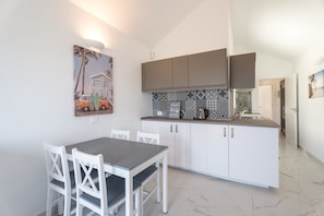 A modern kitchen with white cabinets, a grey countertop, and a tiled backsplash. - Vacation Apartment 'Leo Frente & Amarilla Golf' with Sea View, Shared Pool and Wi-Fi (Amarilla Golf)