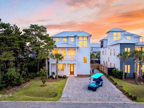 A residential complex with multiple two-story houses, a paved driveway, and a golf cart. - Sun Drift: Private beach steps away, Heated pool, FREE golf cart, Bunk Rooms (Miramar Beach)