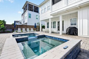 A residential property with a swimming pool, outdoor seating, and a covered patio area. - Sun Drift: Private beach steps away, Heated pool and spa, FREE golf cart (Miramar Beach)