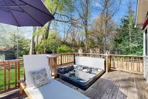 A hot tub on a wooden deck with a wooden railing and a lounge chair with a cushion. - Dartwood Dunes, Dunes, Lakes, Union Pier, Hot Tub (Union Pier)