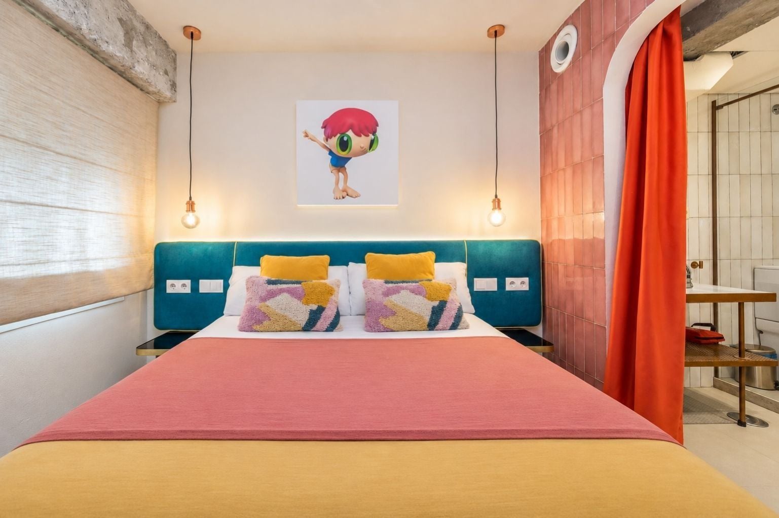 A hotel room with a bed, a headboard, a wall-mounted artwork, and a window with blinds.