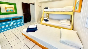 A bunk bed room with a blue dresser, white walls, and a framed picture on the wall. - Apto 4B Flamenco Beachfront Villas with Ocean View (Flamenco)