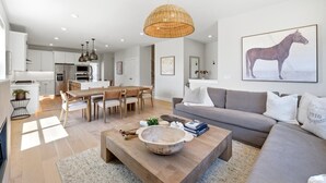 Una sala de estar moderna con un sofá, una mesa de centro y un comedor.