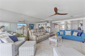 A spacious living room with a large sofa, a recliner, and a blue couch. - Minorca The Inlet 1305 (New Smyrna Beach)