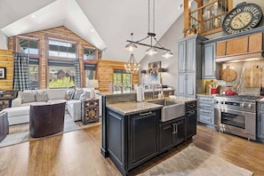 A spacious kitchen with a large island, modern appliances, and a view of the outdoors. - Buckhorn Townhome 264 - 5 Bedroom (Beaver Creek)