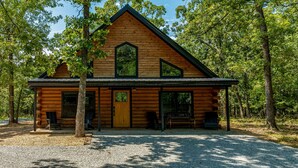 A log cabin with a gabled roof, large windows, and a porch. - Modern Log Cabin - Boat Ramp & Rock Crawl nearby (Eucha)