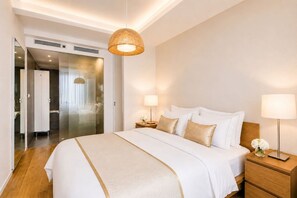 A hotel room with a large bed, bedside lamps, a wooden nightstand, and a woven pendant light. - Trendy Karlin Escape Near Old Town (Prague 8)